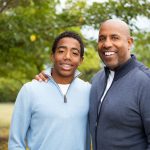 Smiling Father talking and spending time with his son