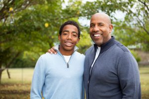 Smiling Father talking and spending time with his son