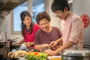 Young adult learning to prepare food