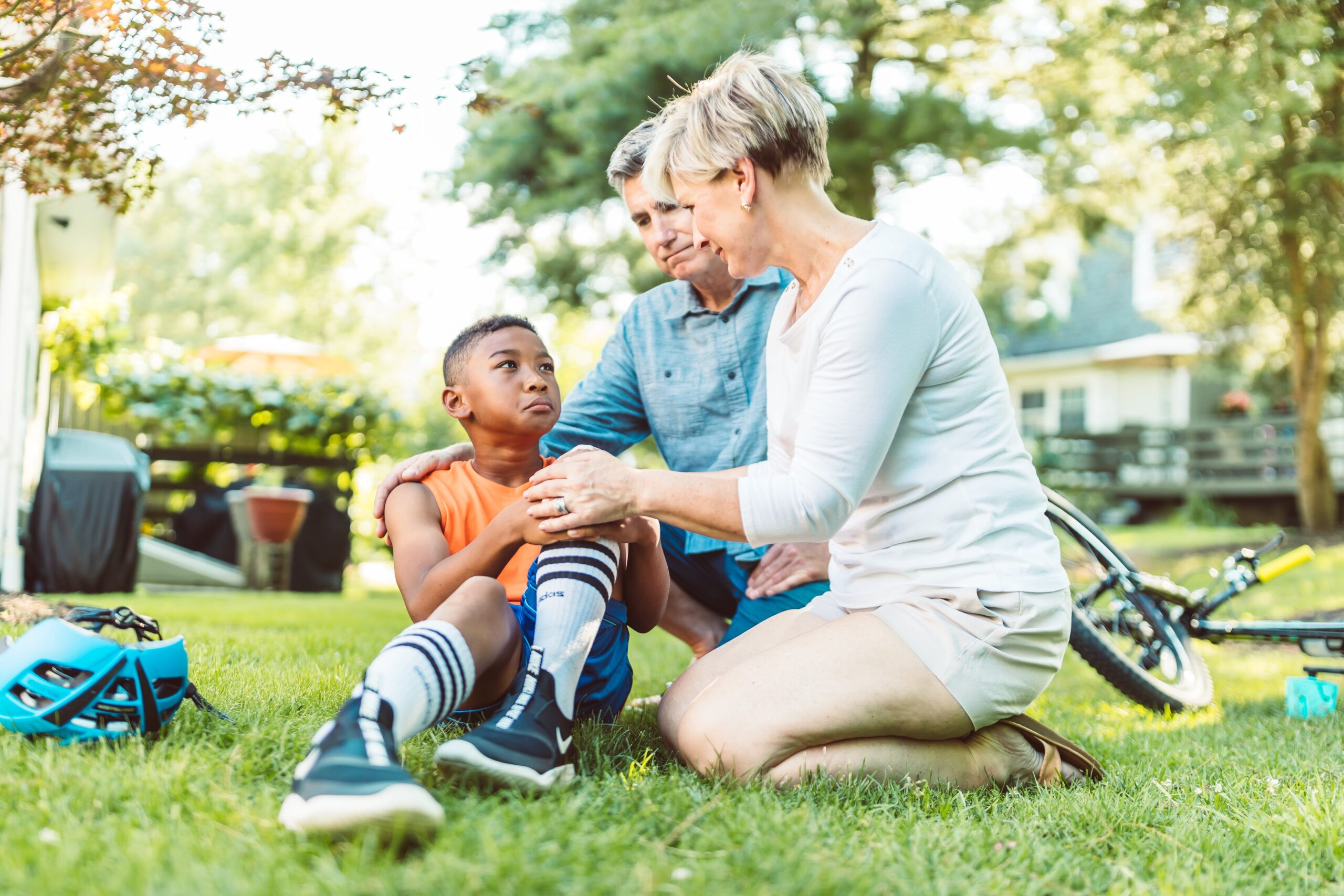 Parents soothing a child who fell off his bike, Understand and Support Your Neurodivergent Child: From Misbehavior to Stress Response