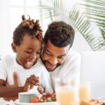 Father and son having fun, eating breakfast together - Peace At Home Parenting Solutions,  Trust Your Gut as a Parent: When to Follow (or Question) Professional Advice